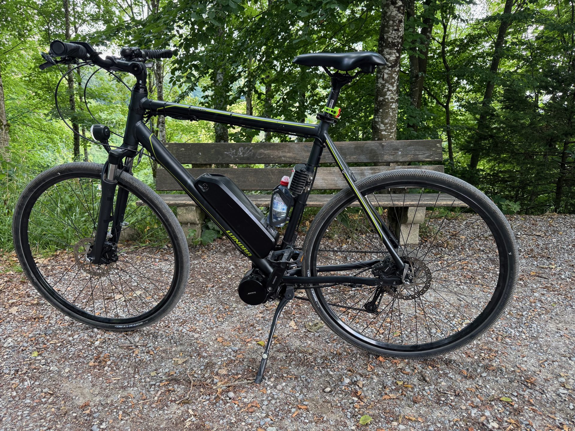 The converted Winora on a gravel forest path, on Schwalbe G-One tyres with the handlebars set low